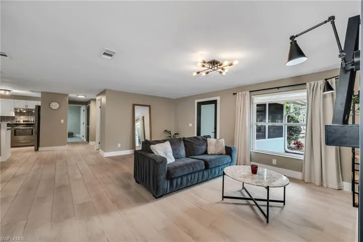 Family room  featuring light wood plank porcelain tile flooring