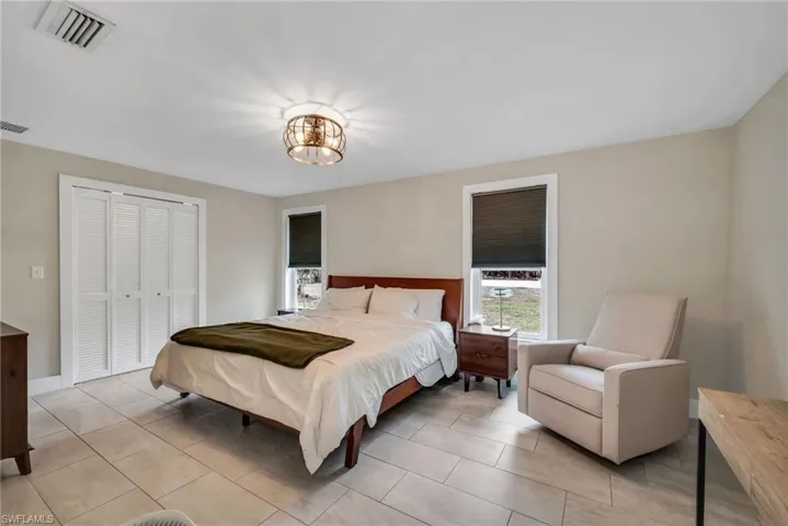 Bedroom featuring limewash paint and tile flooring