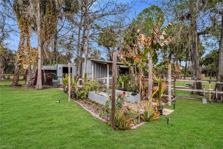 View of lawn featuring a vegetable garden