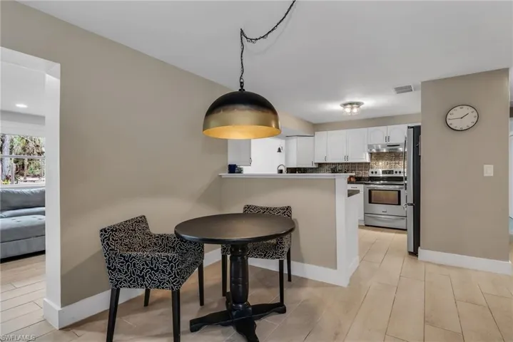 Breakfast area featuring pendant light and light wood plank porcelain tile flooring