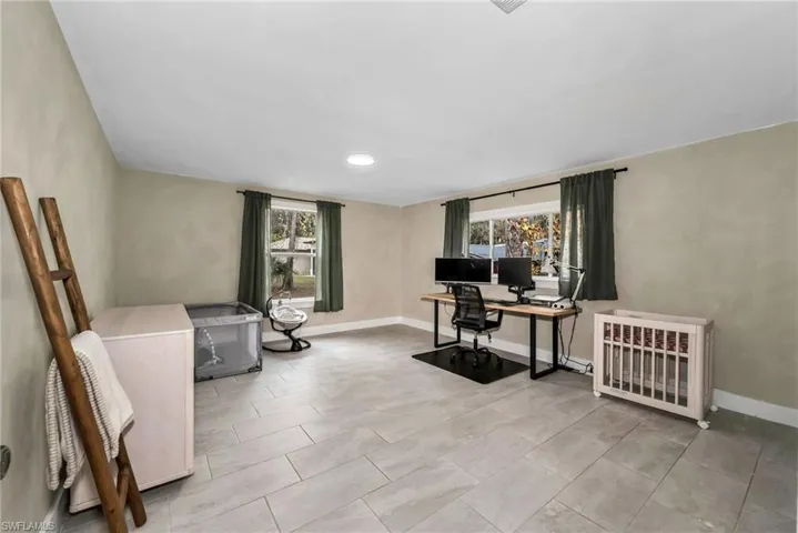 2 Guest bedroom featuring limewash paint and tile flooring