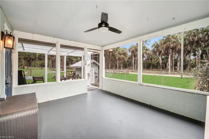 Screened in sunroom with a ceiling fan
