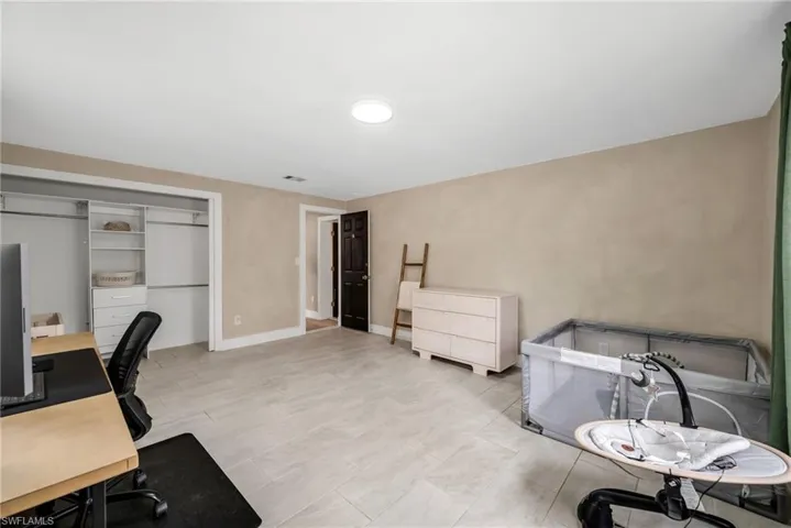 2 Guest bedroom   featuring limewash paint and tile flooring