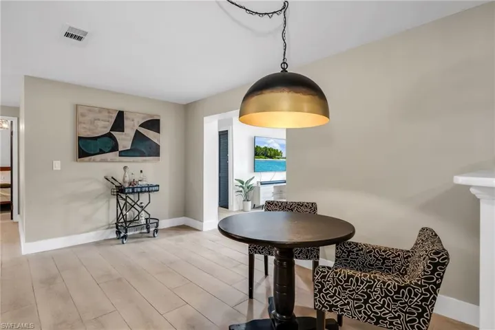 Breakfast area featuring pendant light and light wood plank porcelain tile flooring