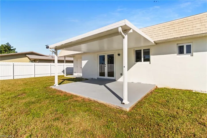 Back of house featuring a patio, french doors, and stucco siding