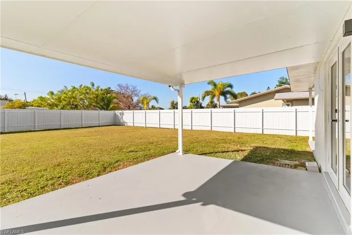 Fenced backyard with a patio