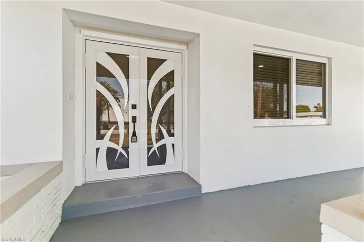 Property entrance with french doors and stucco siding