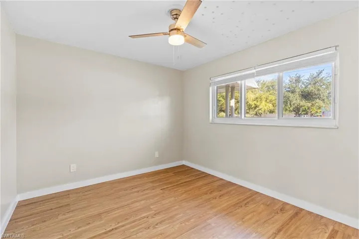 Unfurnished room featuring light wood-style flooring and a ceiling fan
