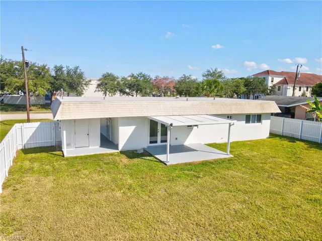 Back of house featuring a fenced backyard, a patio area, and stucco siding