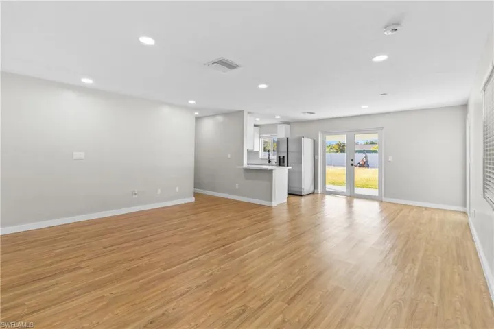Unfurnished living room with light wood-style floors and recessed lighting