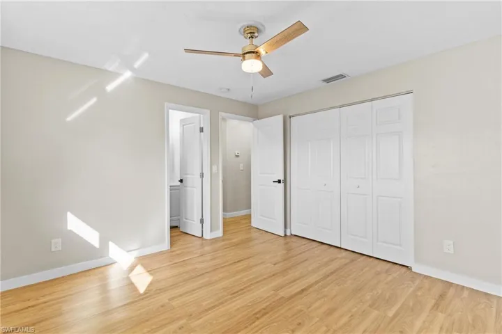 Unfurnished bedroom featuring light wood-style flooring, a ceiling fan, and a closet