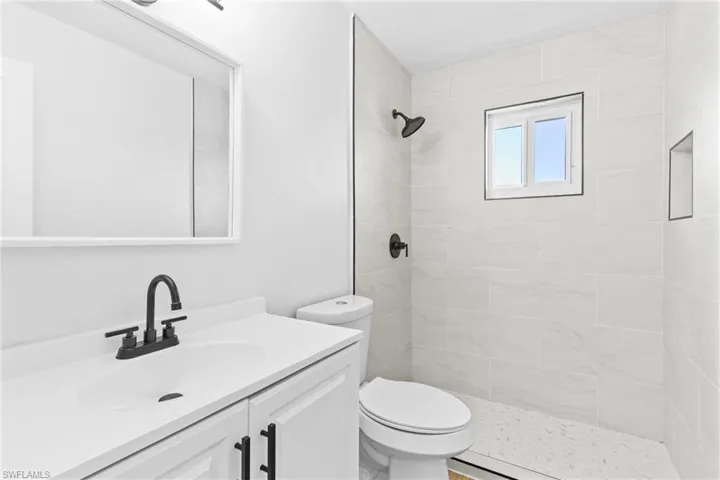 Full bath featuring vanity and a stall shower