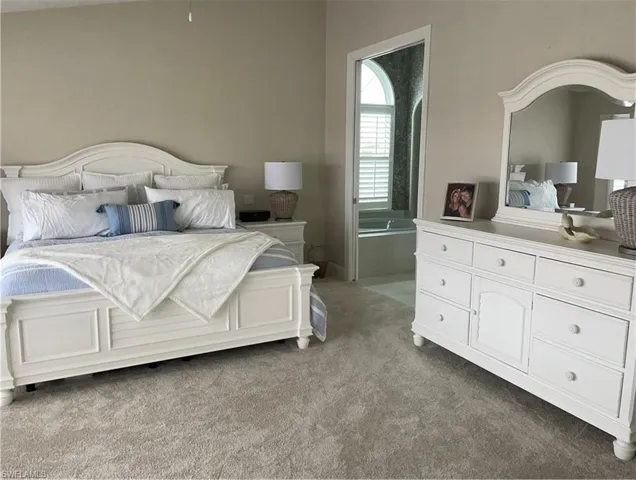 The photo does not do this bedroom justice. It’s big, beautiful with impact windows running the entire wall, overlooking the pool and canal. There are also cedar dorma closets for storage.
