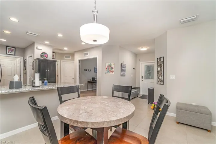 Dining space featuring light tile patterned floors