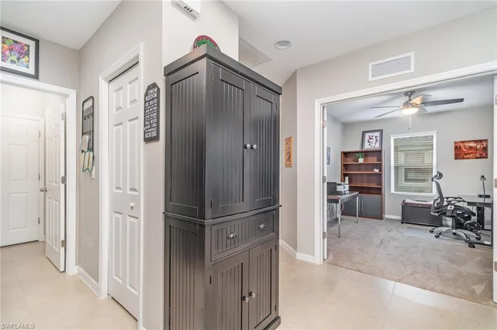 Hallway featuring carpeted den view