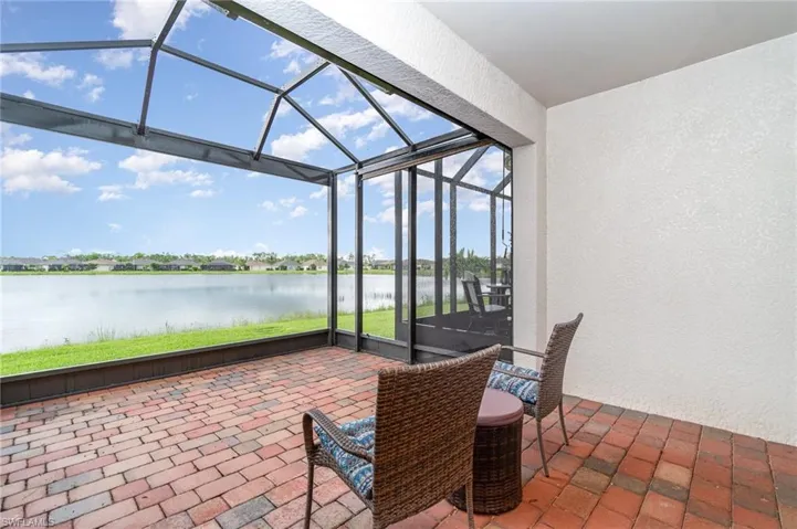 Sunroom featuring a water view