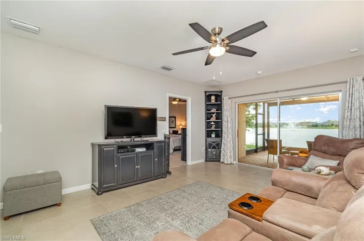 Living room featuring ceiling fan and light tile patterned floors