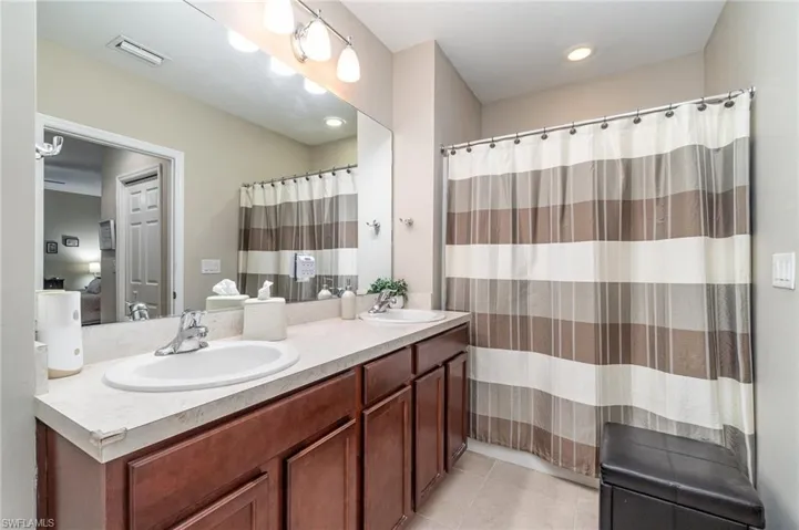 Primary Bathroom featuring double sinkvanity and tile patterned flooring