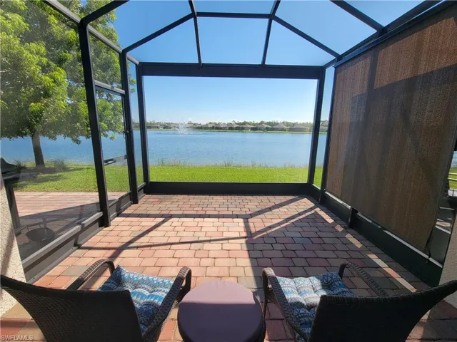 Screened lanai - day view featuring shade for privacy, a water view, and a wealth of natural light