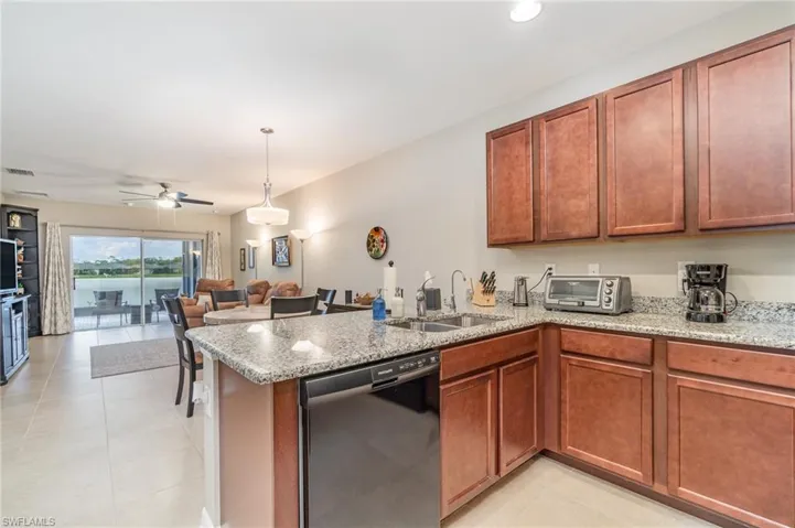 Kitchen with dishwasher, kitchen peninsula, sink, granite countertops, and recessed lighting