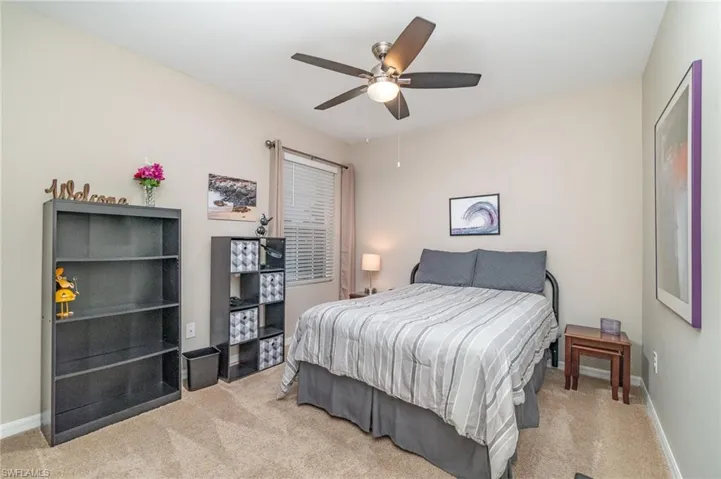 Guest bedroom carpeted with ceiling fan and a closet