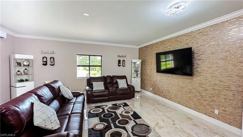 Living room with tile patterned floors and crown molding