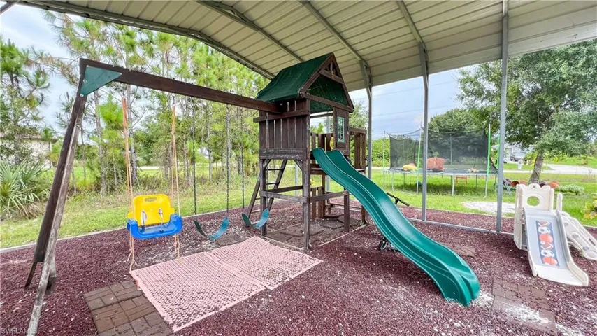 View of jungle gym featuring a trampoline