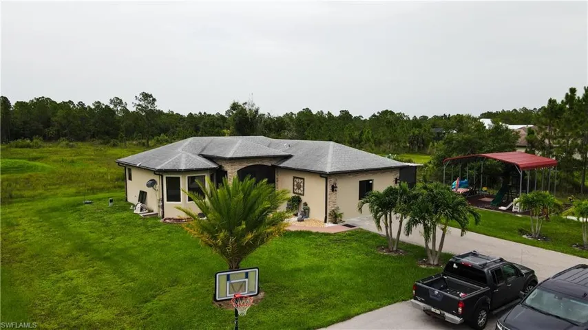 View of front of home featuring a playground and a front lawn