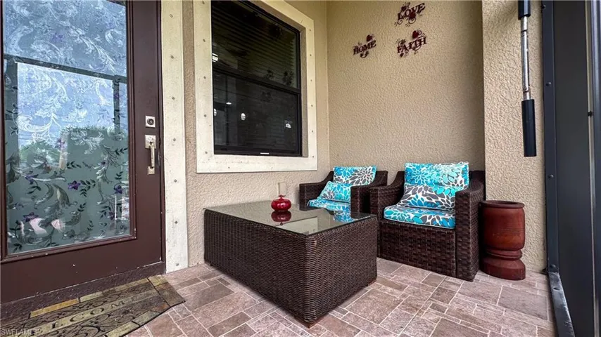 Doorway to property with a patio area