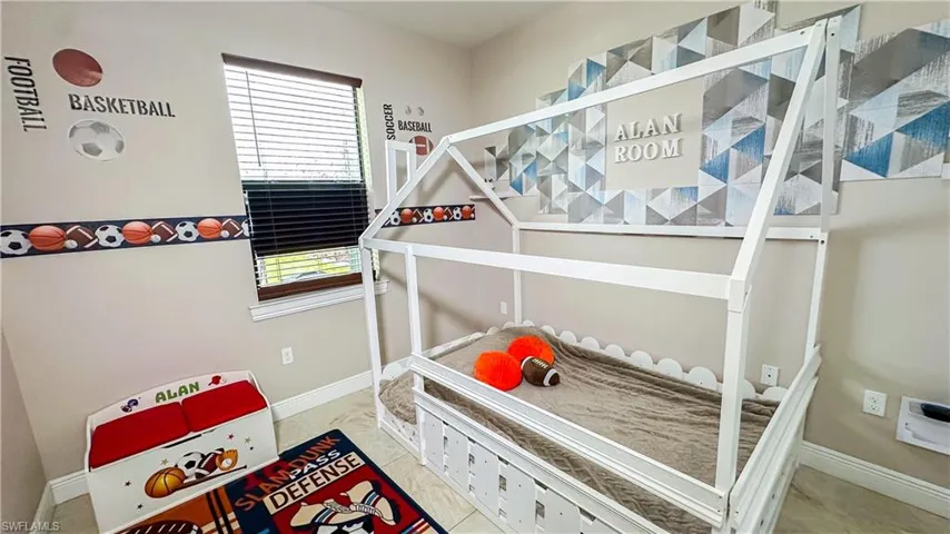 Bedroom featuring multiple windows and light tile patterned floors