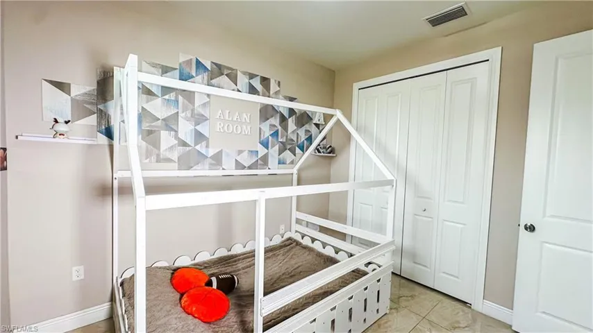Tiled bedroom with a closet
