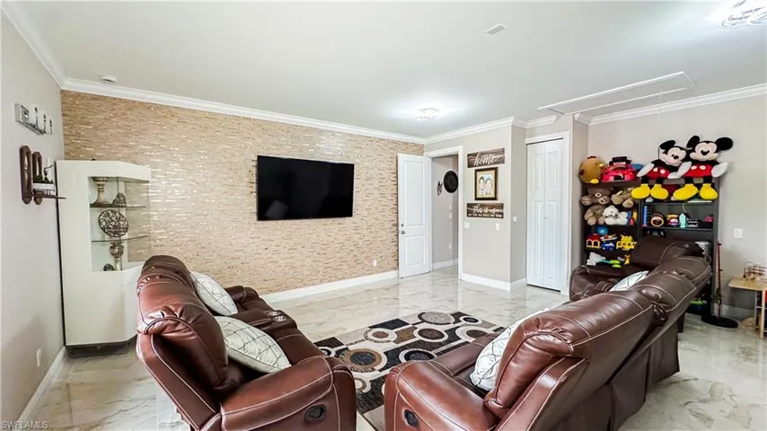 Tiled living room featuring crown molding