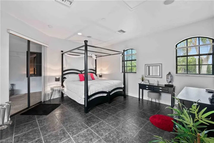 Spacious room featuring dark square tile flooring