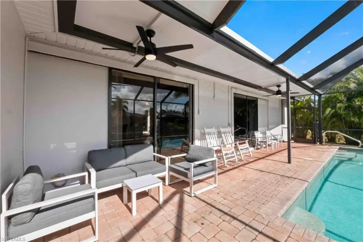 View of patio featuring a lanai, ceiling fan, and an outdoor hangout area
