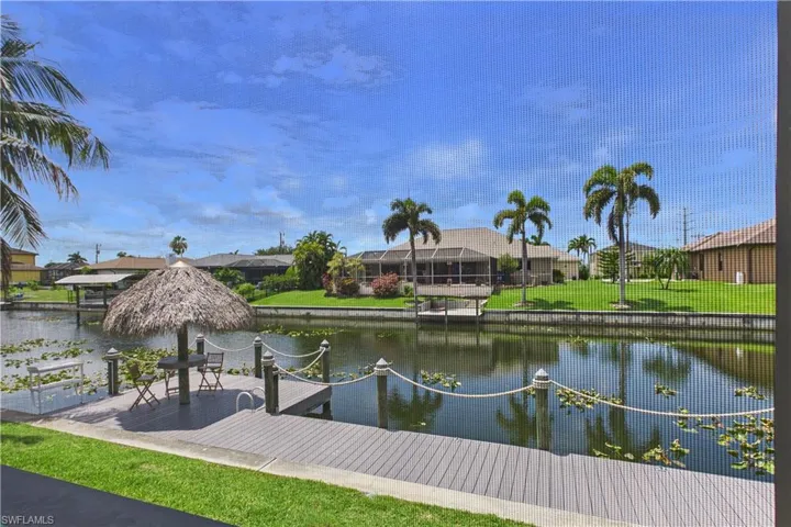 Waterfront dock with a thatched tiki hut