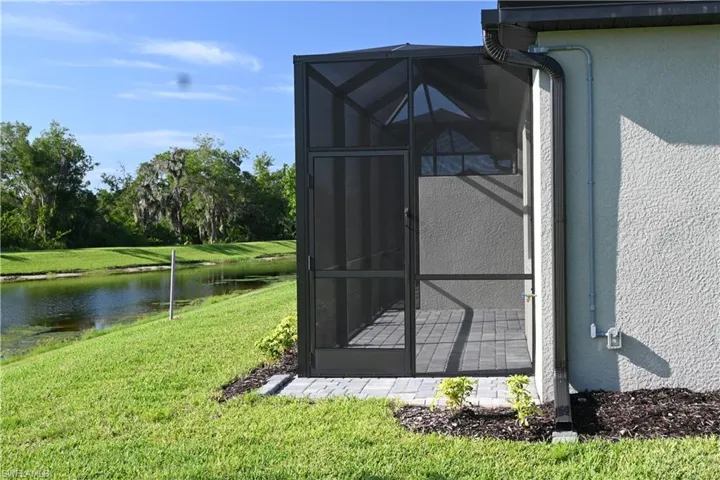 View of outdoor structure with a sunroom and a water view