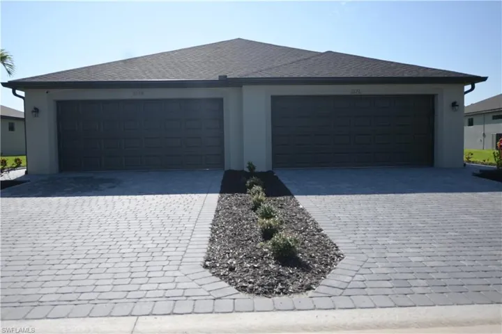 Garage featuring decorative driveway