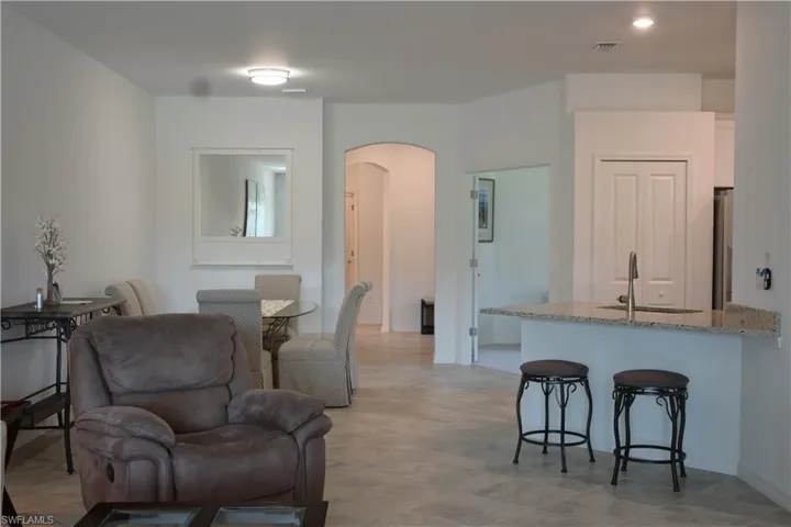 Living room with arched walkways and recessed lighting