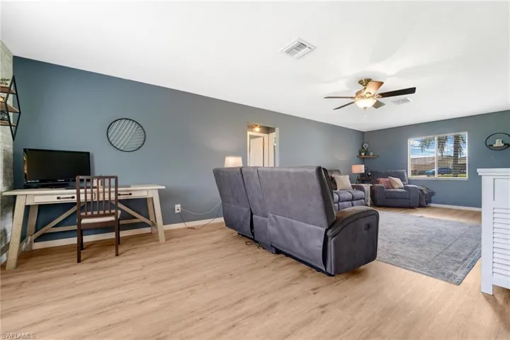 Living room featuring light hardwood / wood-style flooring and ceiling fan