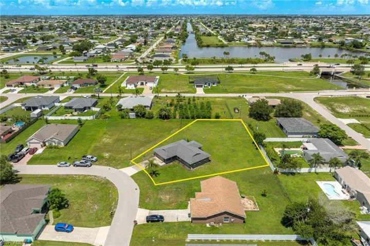 Birds eye view of property with a water view