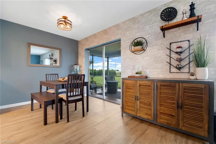 Dining room featuring light hardwood / wood-style floors and brick wall