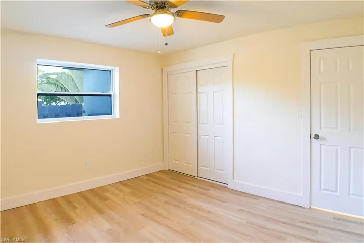 Unfurnished bedroom featuring a closet, ceiling fan, and light wood-type flooring