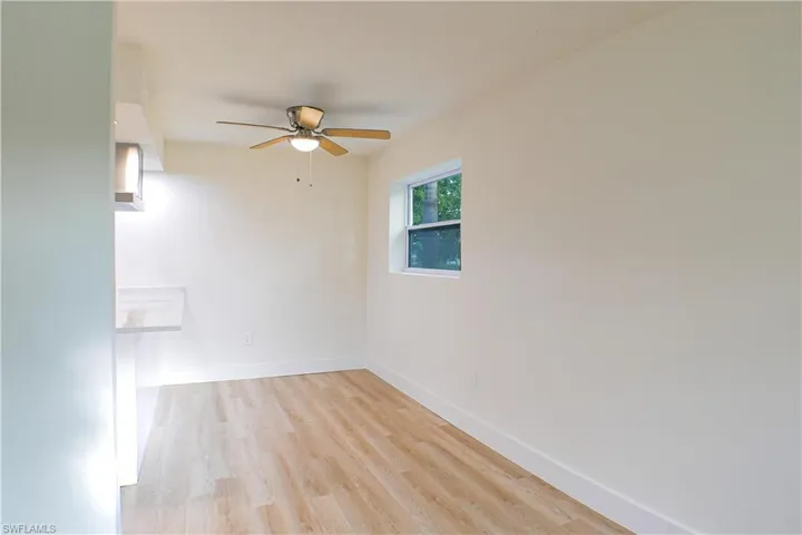Empty room featuring light wood-type flooring and ceiling fan