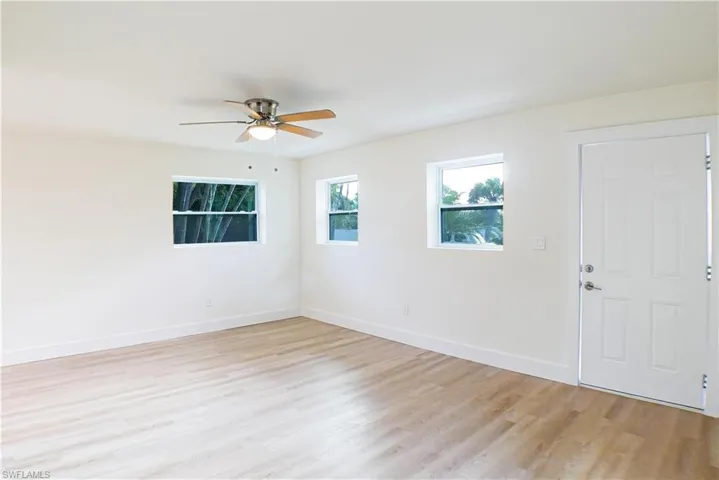 Unfurnished room with light hardwood / wood-style flooring and ceiling fan