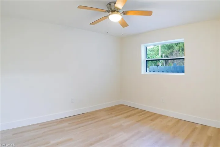 Empty room with light wood-type flooring and ceiling fan