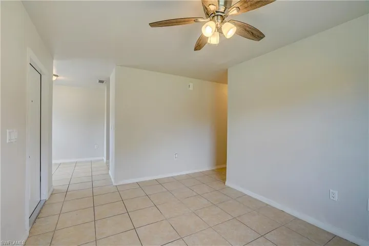 Spare room with ceiling fan and light tile patterned floors