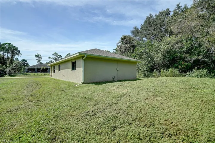 View of side of home with a lawn