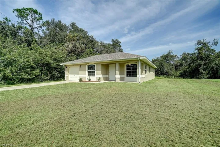 Ranch-style home featuring a front yard