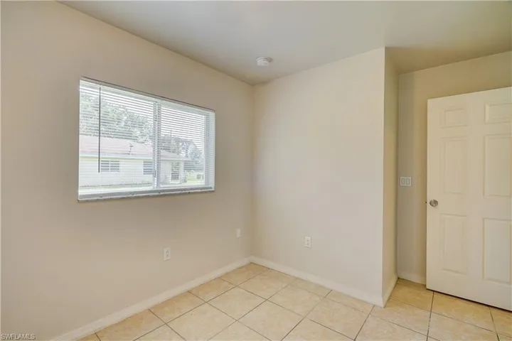Empty room with light tile patterned flooring