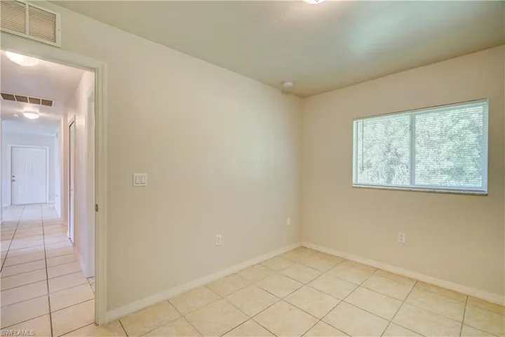 Unfurnished room with light tile patterned floors
